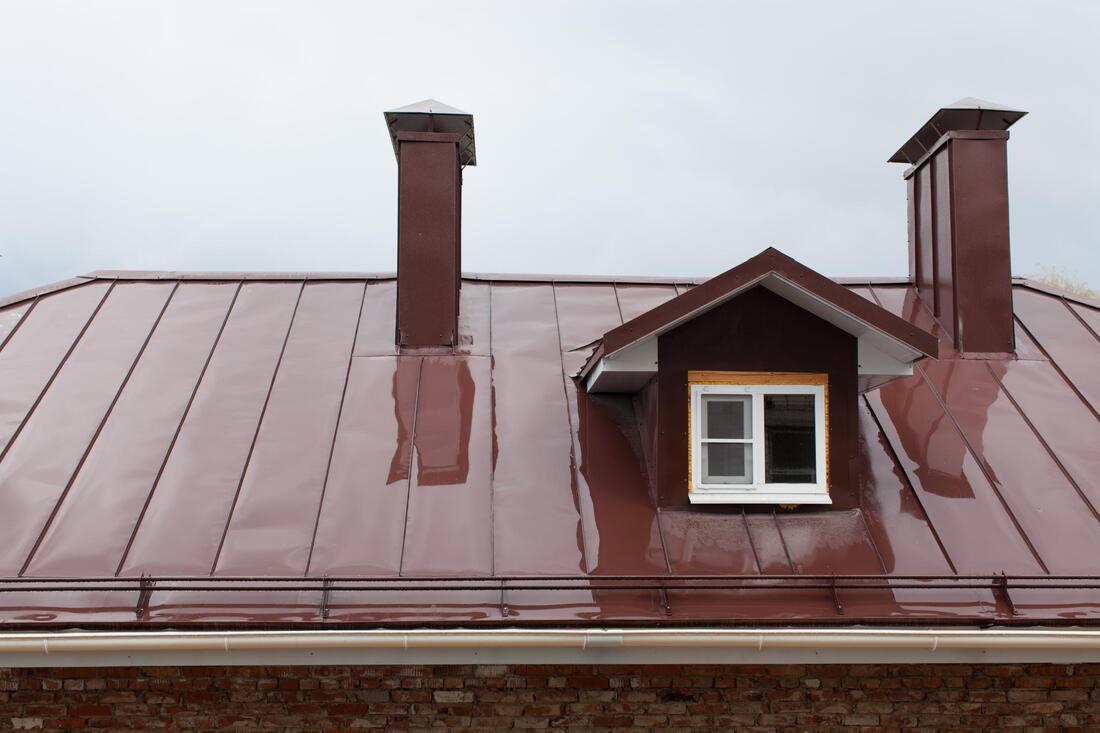 an older home with a new metal roof
